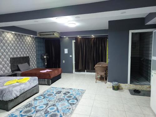 a bedroom with two beds and a living room at Best Dreams Hotel in Cairo