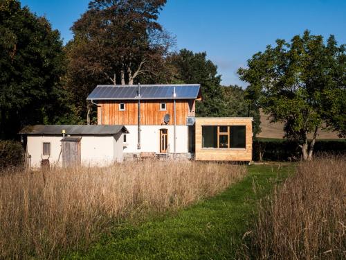 a house with a solar roof on top of a field at Bahnwärterhaus in Droßdorf