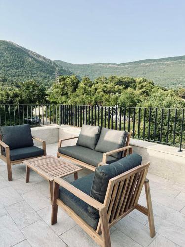 two chairs and a coffee table on a patio at Adriatic Dream in Tivat