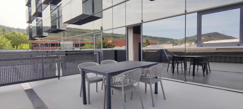 a black table and chairs on a balcony at Hotel Apartamentos San Fermín Pamplona in Pamplona