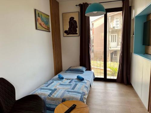 two twin beds in a room with a window at Adriatic Dream in Tivat