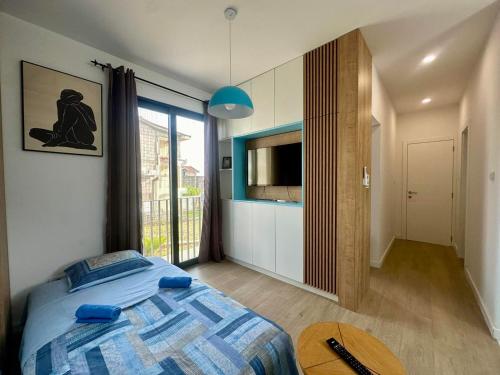 a bedroom with a bed and a television and a table at Adriatic Dream in Tivat