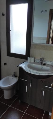 a bathroom with a sink and a toilet at Casa rural La Abuela in El Ronquillo