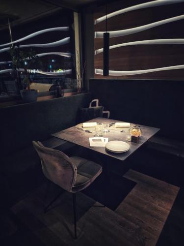 a dining room with a table and a chair at Gourmet AlpinHotel Sonnleiten in Cadipietra