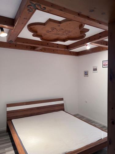 a bed in a bedroom with a wooden ceiling at ROYAL RACiING SUITE TOP 4 in Judenburg