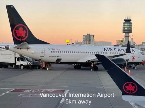 an air canada airplane parked at an airport at Near Skytrain and QUIET Private Bedroom Ensuite BathRM, Free Wifi & Coffee, Cozy in Burnaby