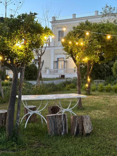 a white picnic table in front of a house with lights at Villa De Cillis Carafa in Torre del Greco