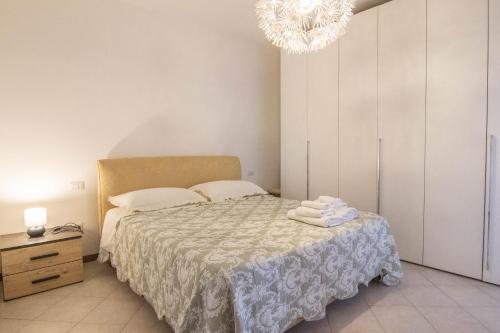 a bedroom with a bed and a chandelier at Daniel's House in Pontedera