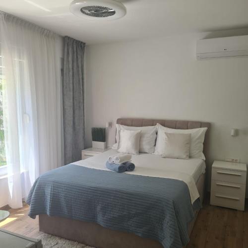 a bedroom with a bed with two stuffed animals on it at Villa Queen in Zadar
