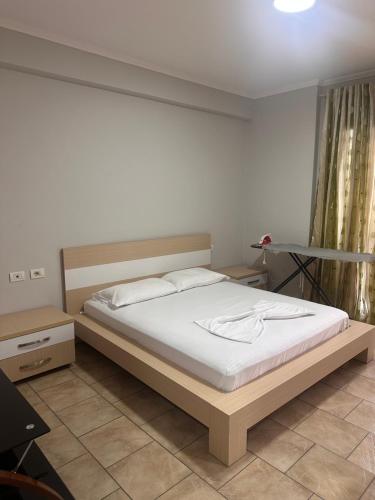 a bedroom with a bed and a desk in it at Adrian Apartment in Orikum