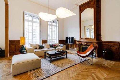 un salon avec un canapé, une table et un miroir dans l'établissement Prestige cœur historique, à Toulouse