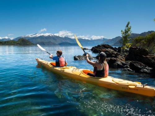 two people in a kayak on the water at Wanaka Springs Lodge in Wanaka