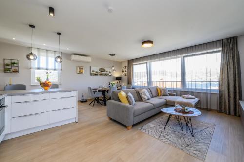 a living room with a couch and a table at Luxury apartment Barka in Villa with heated pool in Vinišće