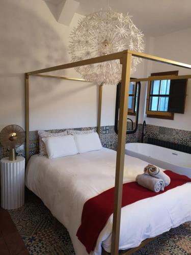 a bedroom with a canopy bed and a bath tub at Casas del Alto Tajo - La Casa Blanca in Ablanque