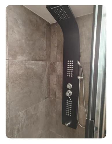 a shower with a black shower head in a bathroom at Simple and Relaxing House! in Kalamata