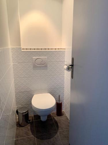 a bathroom with a white toilet in a room at Chambres d'Hôtes Le Clos des 3 Rois in Thouarcé