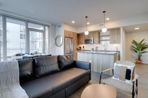 a living room with a couch and a kitchen at Prime Metro Proximity - Condo at Clarendon in Arlington