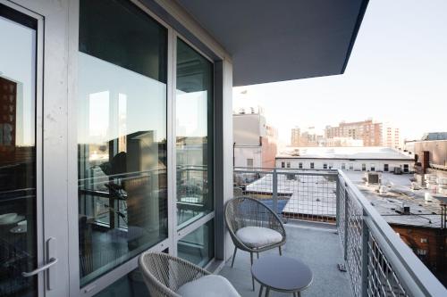 a balcony with chairs and a view of a city at Prime Metro Proximity - Condo at Clarendon in Arlington