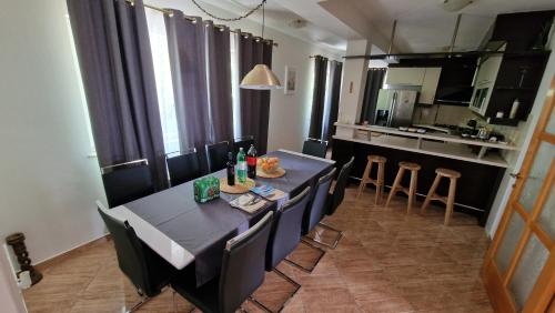 a dining room with a table and chairs and a kitchen at Villa Heaven in Donji Zemunik