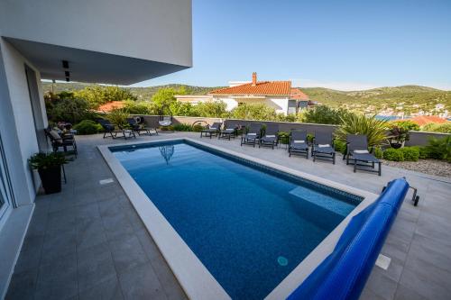 a swimming pool in the middle of a house at Luxury apartment Barka in Villa with heated pool in Vinišće
