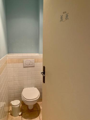 a bathroom door with a toilet in a bathroom at Chambres d'Hôtes Le Clos des 3 Rois in Thouarcé