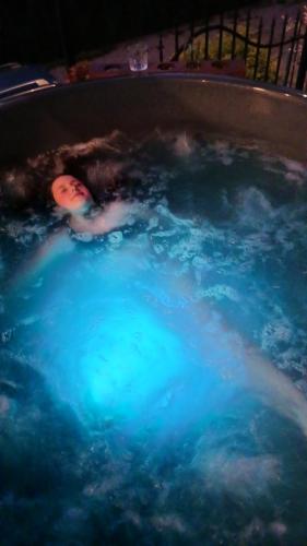 a person in a bath tub with at DOMKI NA WIERCHU in Biały Dunajec