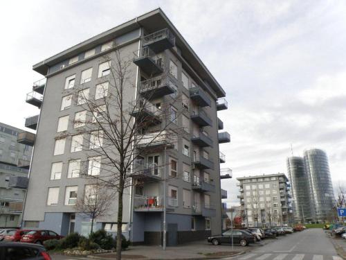 a tall apartment building with balconies on a street at Prestige Apartman Zagreb in Zagreb