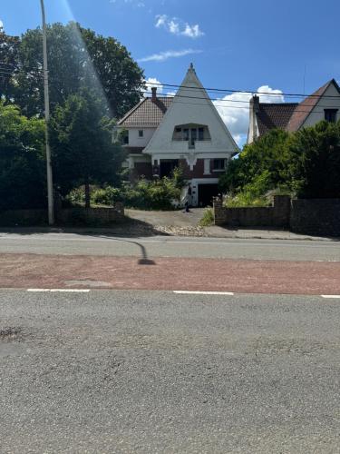 a street with a house in the background with a fire hydrant at la villa dewez a loverval in Gerpinnes