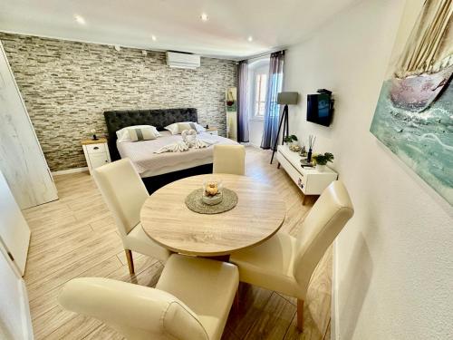 a room with a table and chairs and a bedroom at Primadonna Apartments in Šibenik