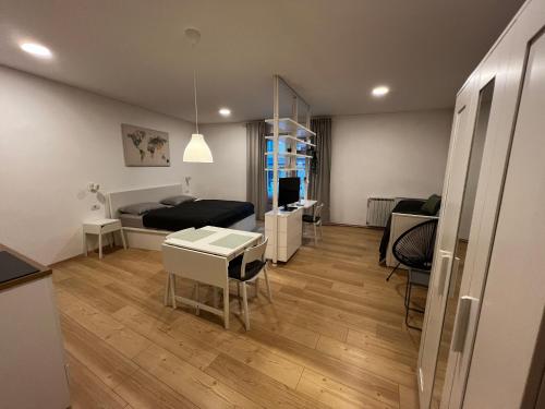 a bedroom with a bed and a table and chairs at GARDEN Apartments in Zagreb