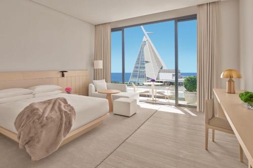 a bedroom with a bed and a view of the ocean at The Jeddah EDITION in Jeddah