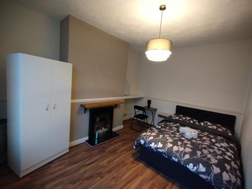 a bedroom with a bed and a fireplace at Double-Bedroom C1 Manchester Close To Bolton Centre in Little Hulton