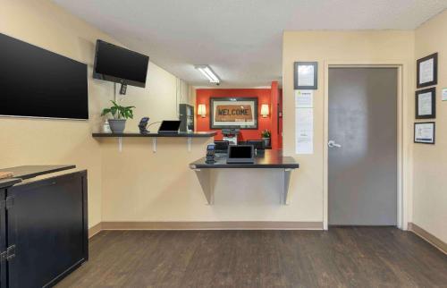 a waiting room with a desk and a computer on a wall at Extended Stay America Suites - Bakersfield - California Avenue in Bakersfield