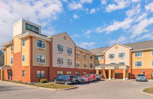 a hotel with cars parked in a parking lot at Extended Stay America Select Suites - Grand Rapids - Kentwood in Grand Rapids
