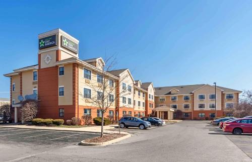 a building with a clock tower in a parking lot at Extended Stay America Suites - Chicago - Woodfield Mall in Schaumburg