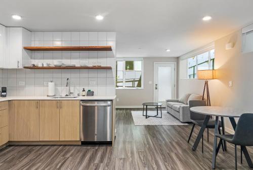 a kitchen and living room with a table and a couch at Dancing Wings Retreat Walker Paradise in Fremont in Seattle