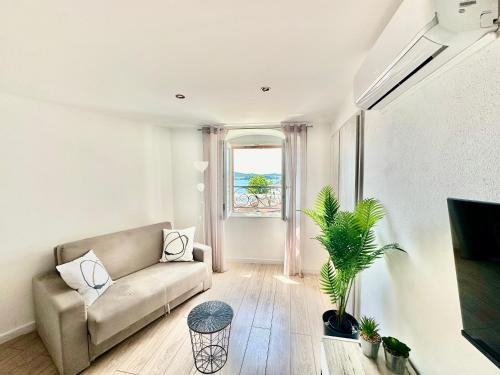 a living room with a couch and a window at Primadonna Apartments in Šibenik