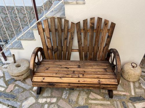 a wooden chair sitting on a floor next to a staircase at Ria Studios in Olhão