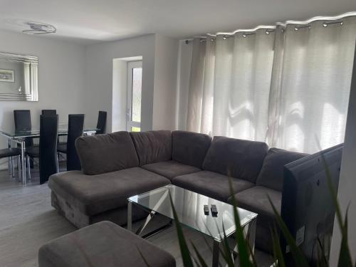 a living room with a couch and a table at Oxford, 2 Bedroom Private Flat with Parking in Oxford