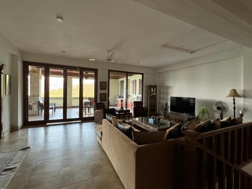 a living room with a couch and a television at 3-BR Murree Hills Hideaway with Scenic View in Murree