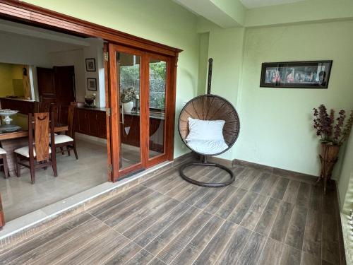 a room with a chair with a pillow on the floor at 3-BR Murree Hills Hideaway with Scenic View in Murree