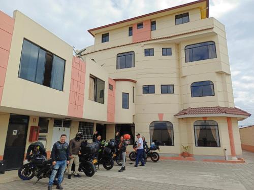 a group of motorcycles parked in front of a building at Hotel Marquez de Rio in Riobamba