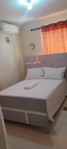 a bedroom with a large bed with white sheets at SDQ Apartamento Marbella 2 in La Ureña