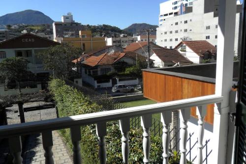 a view of a city from a balcony at Muqui 91 Guesthouse in Teresópolis