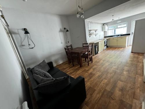 a living room with a couch and a table at Double-Bedroom C2 Manchester Close To Bolton Centre in Little Hulton