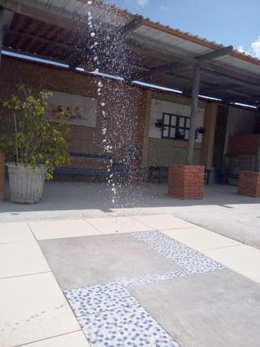 a water fountain in front of a building at Pousada Casa Jardim in Serra Negra