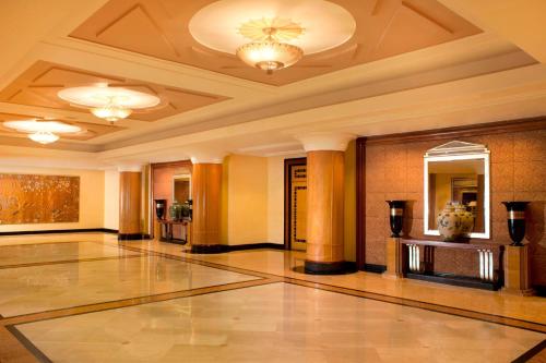 a lobby with a large room with a ceiling at Sheraton Surabaya Hotel & Towers in Surabaya