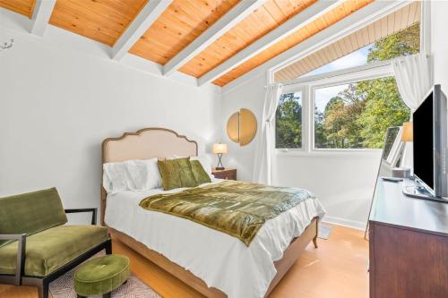 a bedroom with a bed and a desk and a television at Upscale Modern Home with perfect triad location in High Point