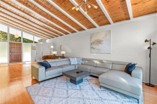 a living room with a couch and a table at Upscale Modern Home with perfect triad location in High Point