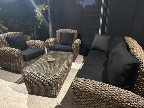 a patio with two chairs and a table and two chairs at Koombana Retreat in Perth